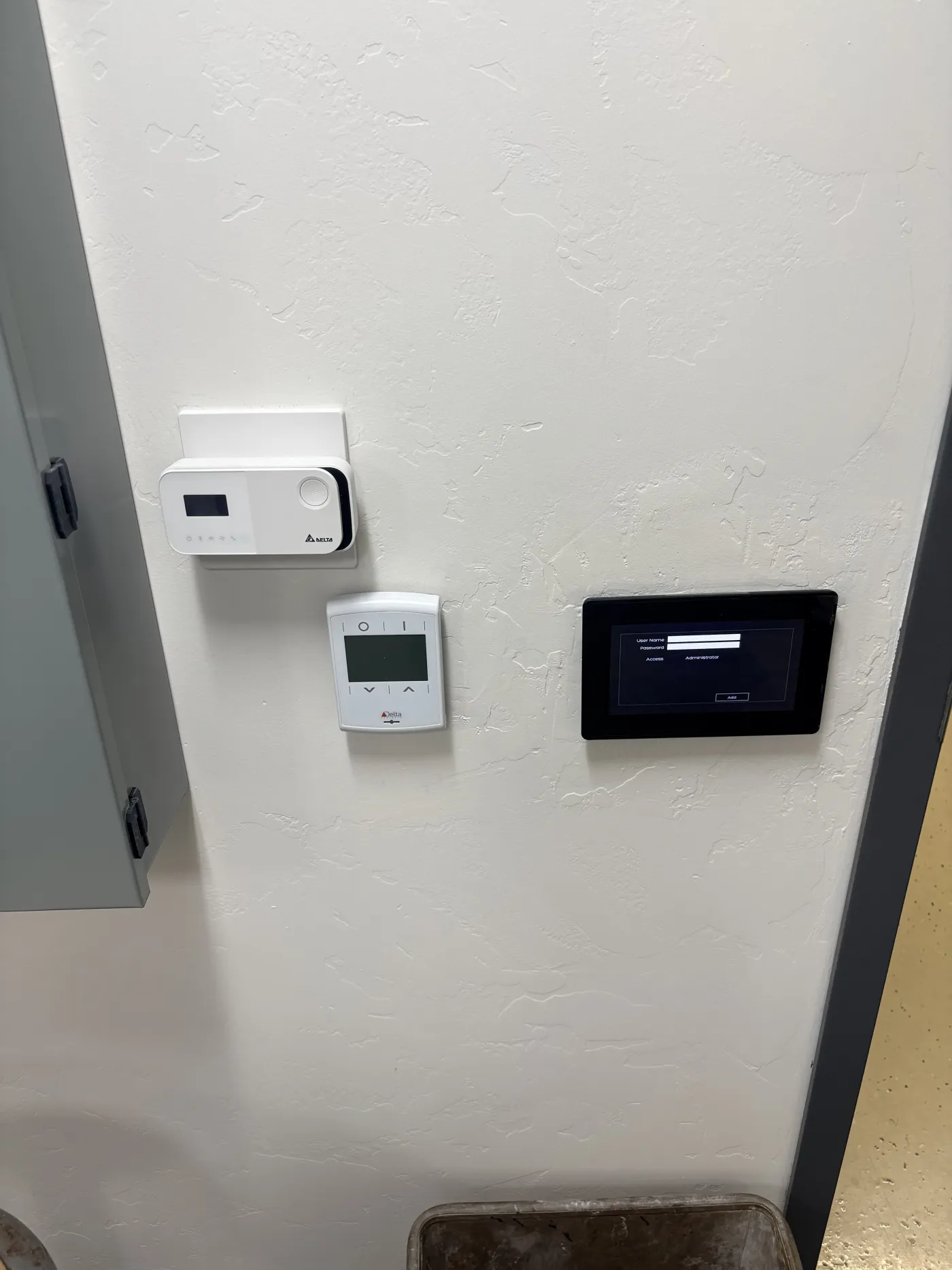 Wall-mounted IAQ monitor, programmable thermostat, and touchscreen interface in one of the chambers.